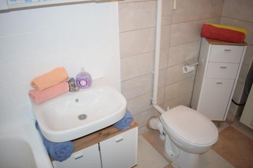 a bathroom with a sink and a toilet at Apartment Optimist/Downtown in Split