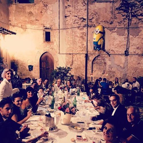 a group of people sitting at a long table at Bed And Breakfast Mblò in Fondi