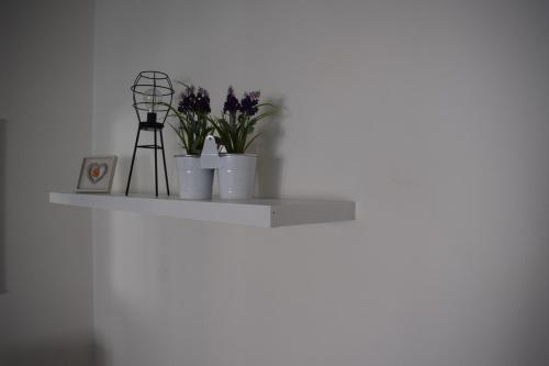 a shelf with flowers and a windmill on it at Apartment Optimist/Downtown in Split