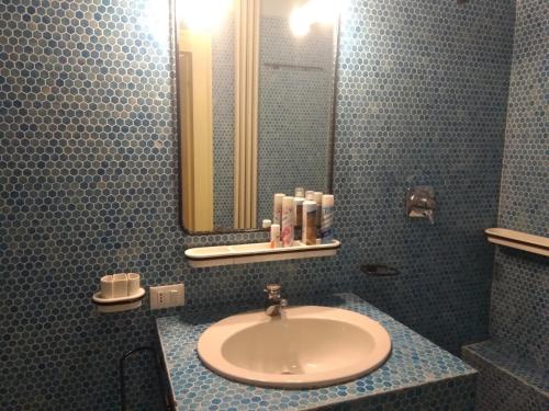 a bathroom with a sink and a mirror at Exclusive Ca Quadri Apartments in Venice