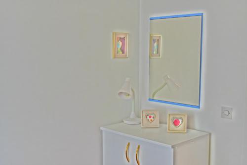 a bathroom with a mirror and a white dresser at Apartment Optimist/Downtown in Split