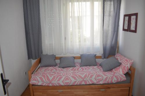 a bed in a room with windows and curtains at Apartment Optimist/Downtown in Split