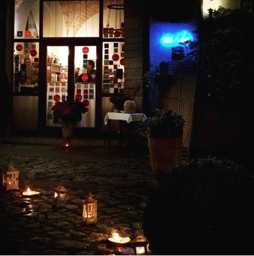 a room with candles in front of a building at night at Bed And Breakfast Mblò in Fondi