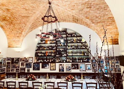 a table in a room with a wall of wine bottles at Bed And Breakfast Mblò in Fondi