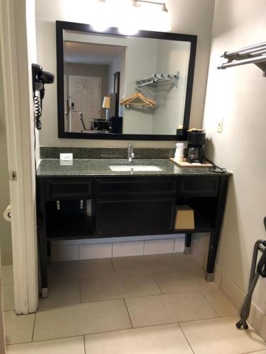 a bathroom with a sink and a large mirror at Deerfield Inn and Suites - Fairview in Fairview