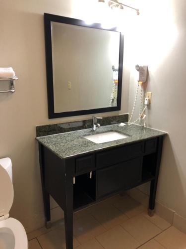 a bathroom with a black sink and a mirror at Deerfield Inn and Suites - Fairview in Fairview