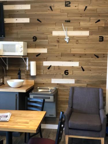 a kitchen with wooden walls and a table and chairs at Deerfield Inn and Suites - Fairview in Fairview