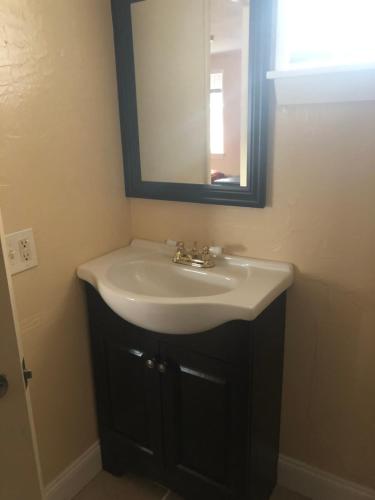 a bathroom with a sink and a mirror at Beachway Motel in Salisbury