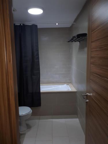 a bathroom with a bath tub and a toilet at Nouaceur Garden Comfort and Serenity Casa Airport in Nouaseur