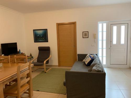 a living room with a couch and a table at Beachouse Algarve in Manta Rota