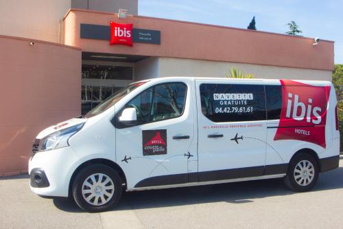 a white van parked in front of a building at ibis Marseille Provence Aéroport in Marignane