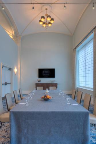 a conference room with a long table and chairs at NOPSI Hotel New Orleans in New Orleans