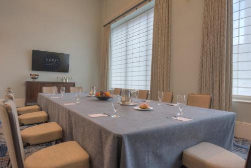 a conference room with a long table and chairs at NOPSI Hotel New Orleans in New Orleans