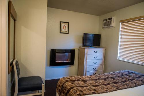 a bedroom with a bed and a tv and a dresser at Big Pines Mountain House in South Lake Tahoe