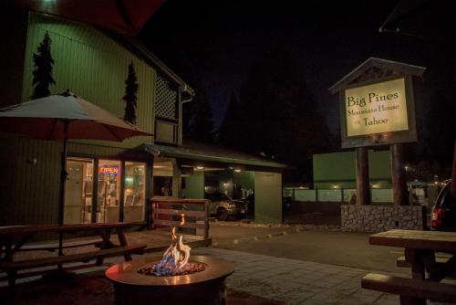 a fire pit in front of a building at night at Big Pines Mountain House in South Lake Tahoe