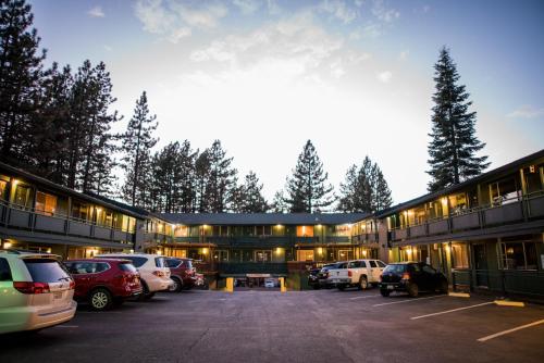 a building with cars parked in a parking lot at Big Pines Mountain House in South Lake Tahoe