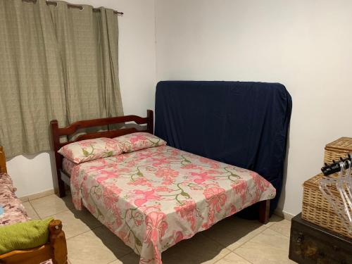 a bedroom with a bed and a blue blanket on it at CASA BUZIOS PRAIA RASA in Búzios