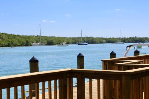 a wooden deck with boats in the water at Gilbert's Resort in Key Largo