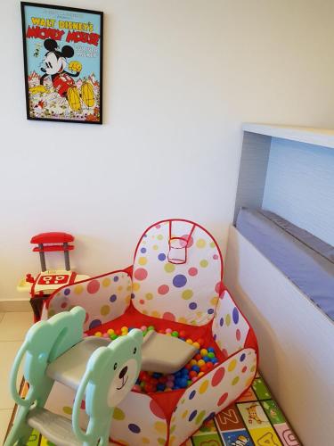 a childs play room with a chair and balls at 1-4pax Mickey Mouse 1bedrm at Puteri Harbour, Teega Suite, Legoland, Lego, Iskandar in Nusajaya