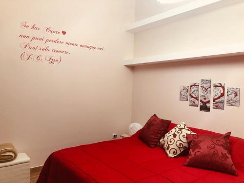 a bedroom with a red bed with a red blanket at Holidays Lecce in Lecce