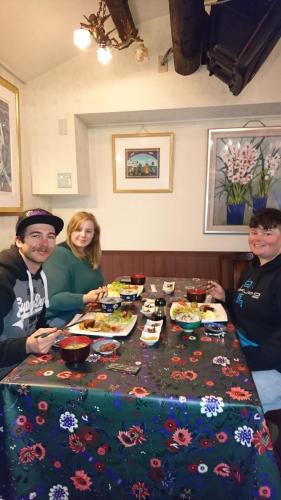 a group of people sitting around a table with food at Live Cafe Hisui no Umi in Itoigawa