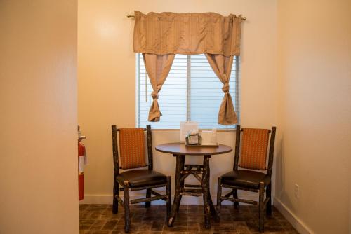 a table and chairs in a room with a window at Big Pines Mountain House in South Lake Tahoe