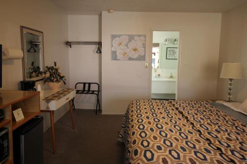 a hotel room with a bed and a desk at Mariners Cove Inn in Westport