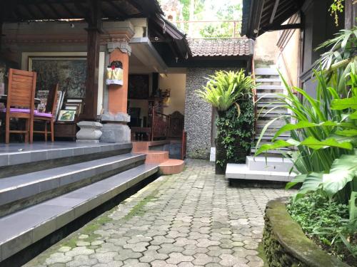 a house with stairs leading to the front entrance at Nirvana Pension in Ubud