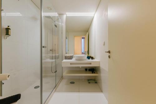 a white bathroom with a sink and a shower at Minimal Lust R2 in Lisbon