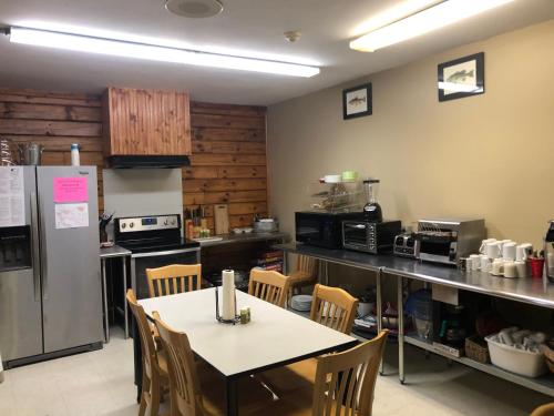 a kitchen with a table and a counter with a refrigerator at Tug Hill Resort in Redfield