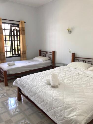 Ένα ή περισσότερα κρεβάτια σε δωμάτιο στο Bí Homestay
