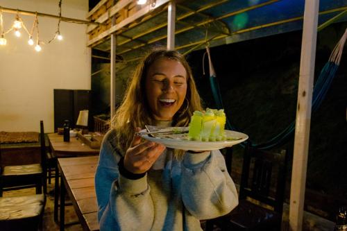 a woman is holding a plate of food at Wander Thirst in Kathmandu
