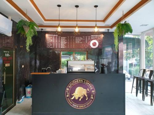 a restaurant with a bear sign on a counter at Aonang Village Resort in Ao Nang Beach