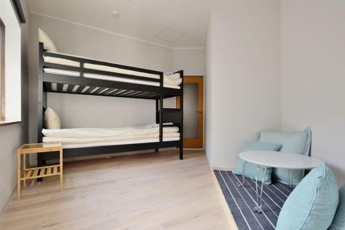 a room with two bunk beds and a table at Vacation House Tennoji 168, Osaka in Osaka