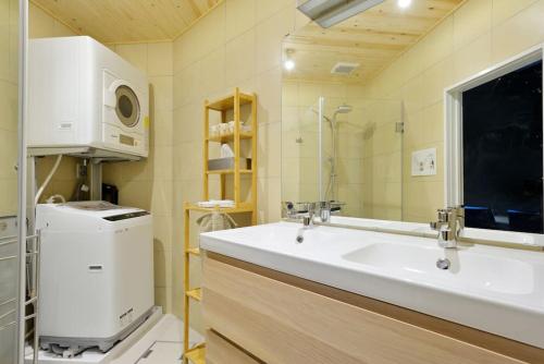 a bathroom with a large sink and a microwave at Vacation House Tennoji 168, Osaka in Osaka