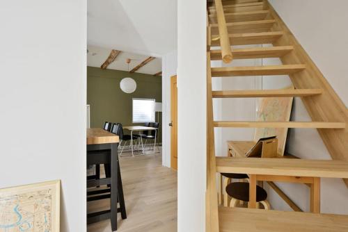 a wooden staircase in a room with a dining room at Vacation House Tennoji 168, Osaka in Osaka
