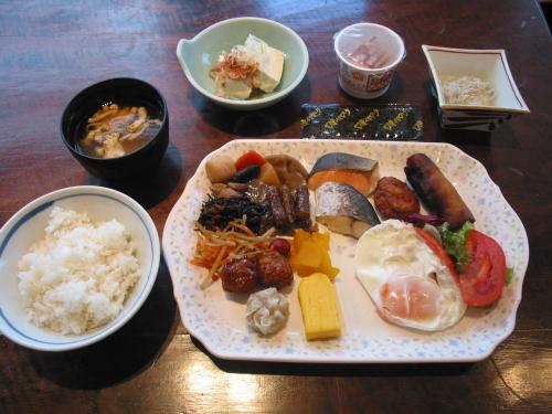 a plate of food on a wooden table with rice at Hotel Kizankan in Tokyo