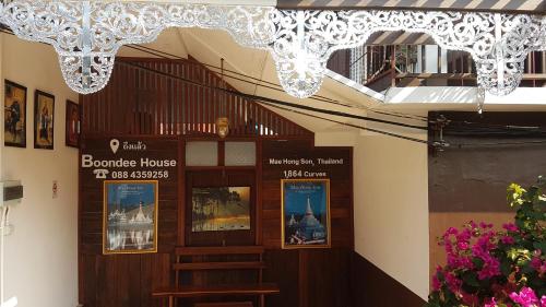 a building with a chandelier hanging from the ceiling at Boondee House in Mae Hong Son