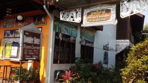 a building with signs on the front of it at Boondee House in Mae Hong Son
