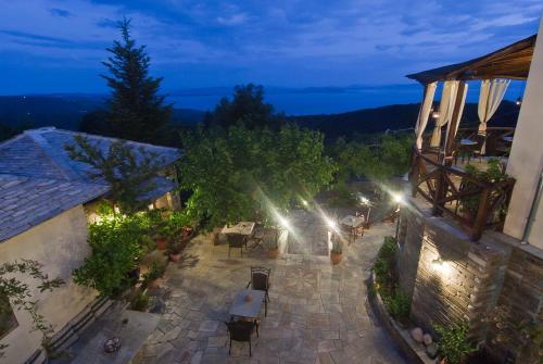 an overhead view of a patio at night with lights at Iliovolo Guesthouse in Miléai