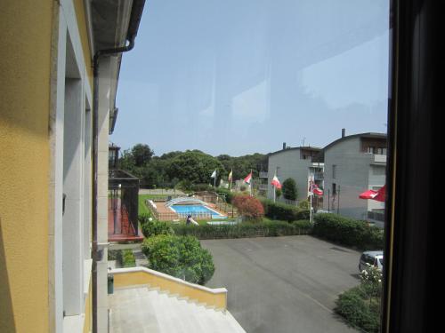 a view from a window of a parking lot with a pool at Hotel Finca La Mansión in Llanes