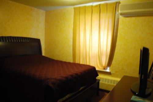 a bedroom with a bed and a window at Chinatown Hotel Chicago in Chicago