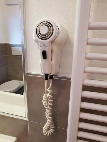 a hair dryer is attached to a wall in a bathroom at Residence La Zondra in Pozza di Fassa