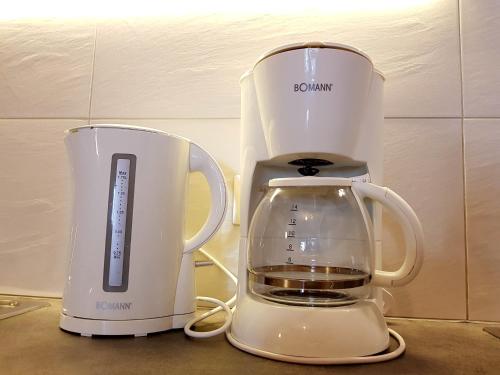 two white appliances sitting next to each other on a counter at Residence La Zondra in Pozza di Fassa