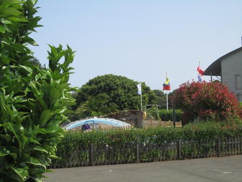 a roller coaster in a park behind a fence at Hotel Finca La Mansión in Llanes