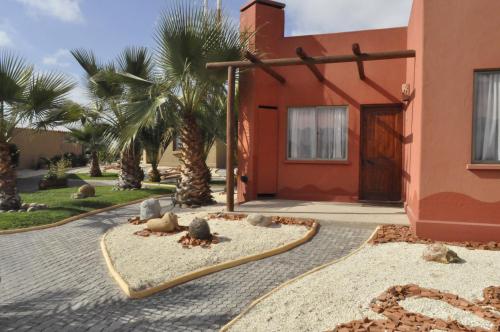 a house with palm trees in front of it at Hotel Serena Suite in La Serena