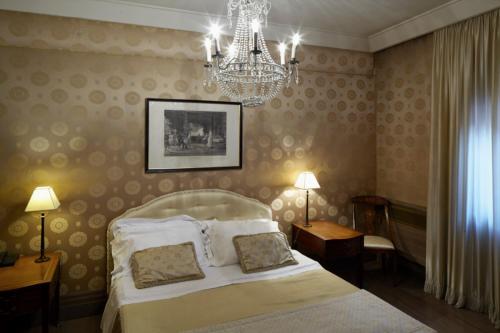 a hotel room with a bed and a lamp at Albergo Cappello in Ravenna