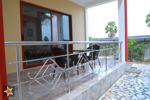 a balcony with a table and chairs on a building at RJ Mahaal Hotel in Kilinochchi