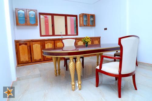 a dining room with a table and a chair at RJ Mahaal Hotel in Kilinochchi