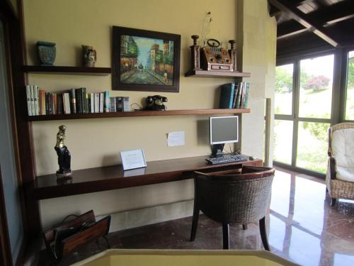a desk with a computer and a chair in a room at Hotel Finca La Mansión in Llanes